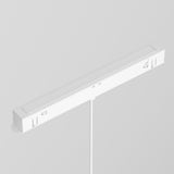 The Luna LED Exility Magnetic Track Pendant Light 5W 3000K in white is a minimalist, modern linear fixture mounted on the ceiling. It features an energy-efficient LED system, a long rectangular shape, and a power cable connecting from the bottom center.