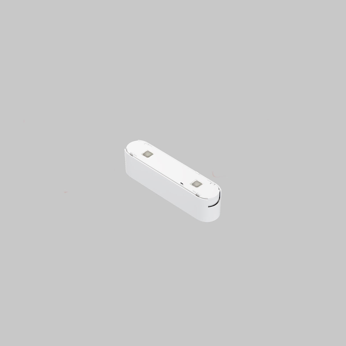 A compact white device, resembling a charging accessory with two metal connectors on top, is set against a gray background. Its minimalist design is reminiscent of the Points LED Linear Track Light for Magnetic Tracks Radity 6W 3000K - White.