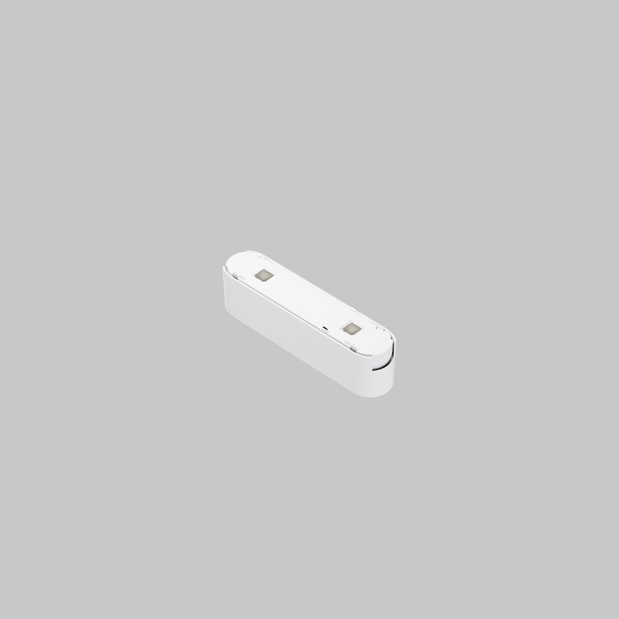 A small white plastic object with a rectangular shape and rounded edges features two electrical contacts on top, resembling a Points LED Linear Track Light for Magnetic Tracks Radity 6W 4000K. It sits against a light gray background, hinting at magnetic track compatibility.