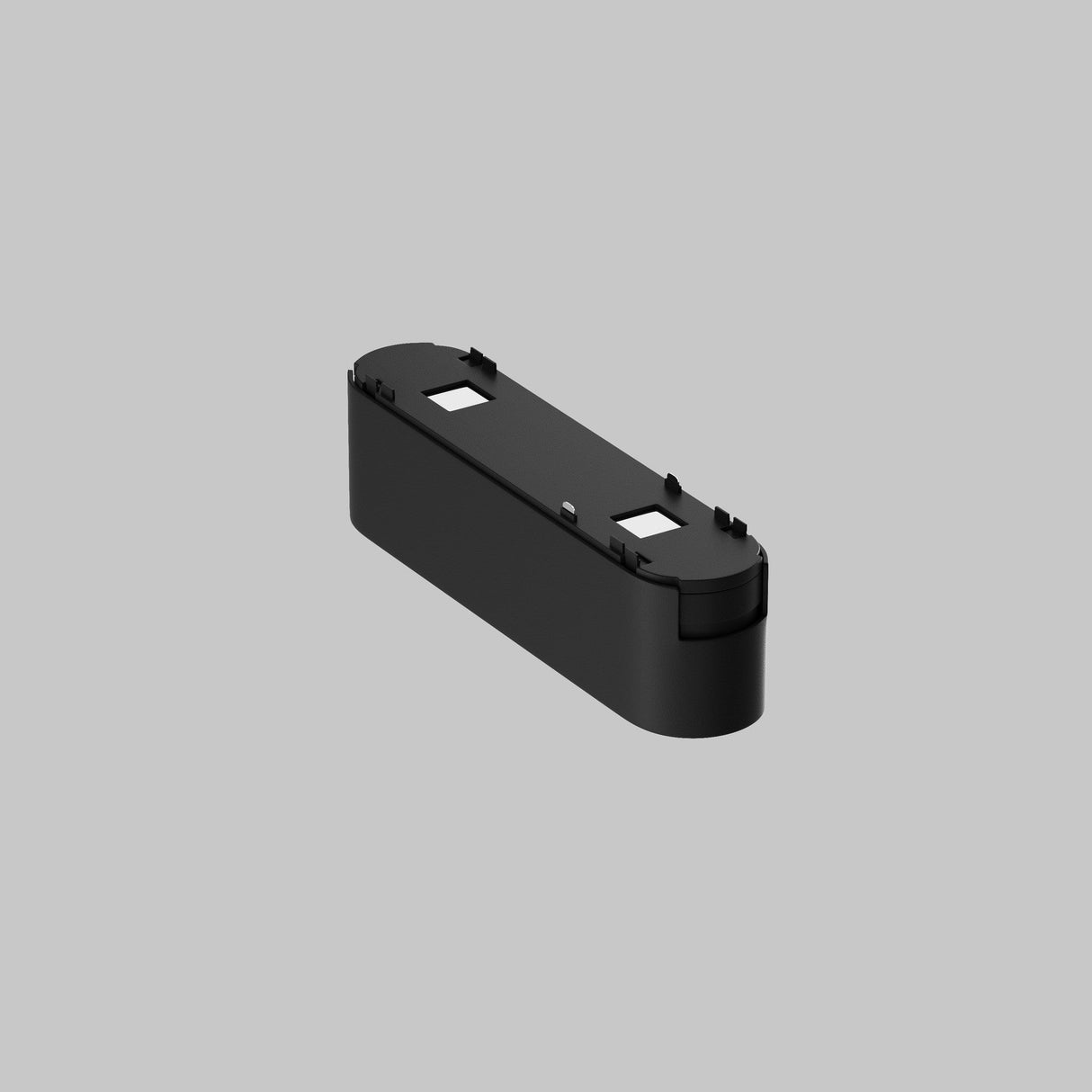 A sleek black, rectangular plastic object with rounded ends and two white labels on top, set against a plain gray background. Perfect for integration with the Basis Grid LED Linear Track Light for Magnetic Tracks Radity 6W 3000K - Black, offering adjustable lighting options.