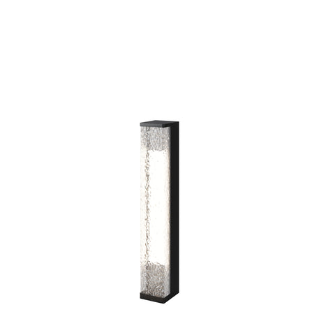 Maytoni Floeva 9W LED bollard light with a tall black metal column and clear textured panels on opposing faces, shown on a white background.