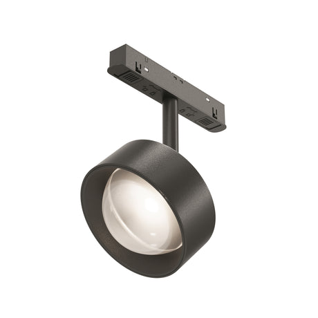 Maytoni Lens Track Spotlight in matt black with a cylindrical pivoting head, recessed lens and single-circuit track adaptor on a plain white background.