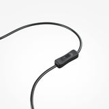 Close-up view of a black headphone cable with an inline remote having a single brass button, all set against a plain white backdrop. Product: Plons LED Table Lamp - Brass.