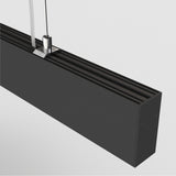 Close-up of the Points LED Linear Suspension Light in black, featuring a sleek rectangular shape suspended by thin wires. Its adjustable height and minimalist design highlight modern lighting trends with clean lines against a white background.