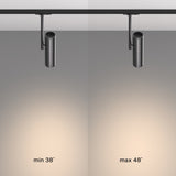 A comparison of black track lights in a single-phase system features the Elti Single Phase Unity Track Spotlight on the left with a minimum beam angle of 38°, and another on the right with a maximum angle of 48°, both casting circles of illumination on a gray background.
