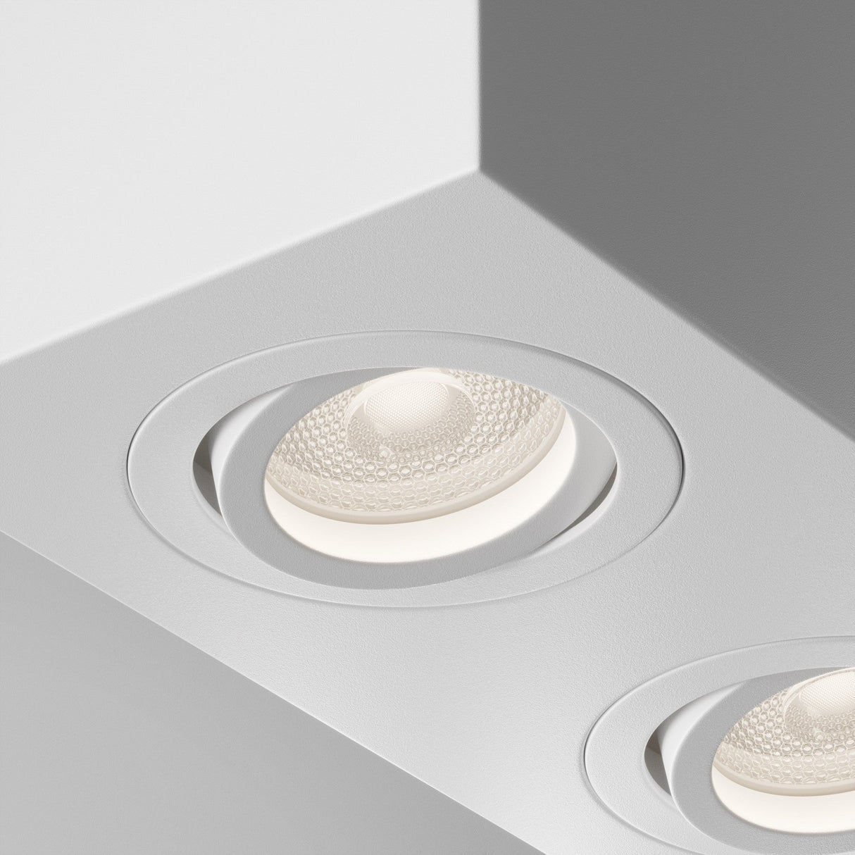 Close-up of the Atom Twin Adjustable Rectangular Surface Mounted Downlight in white, showcasing its refined design.