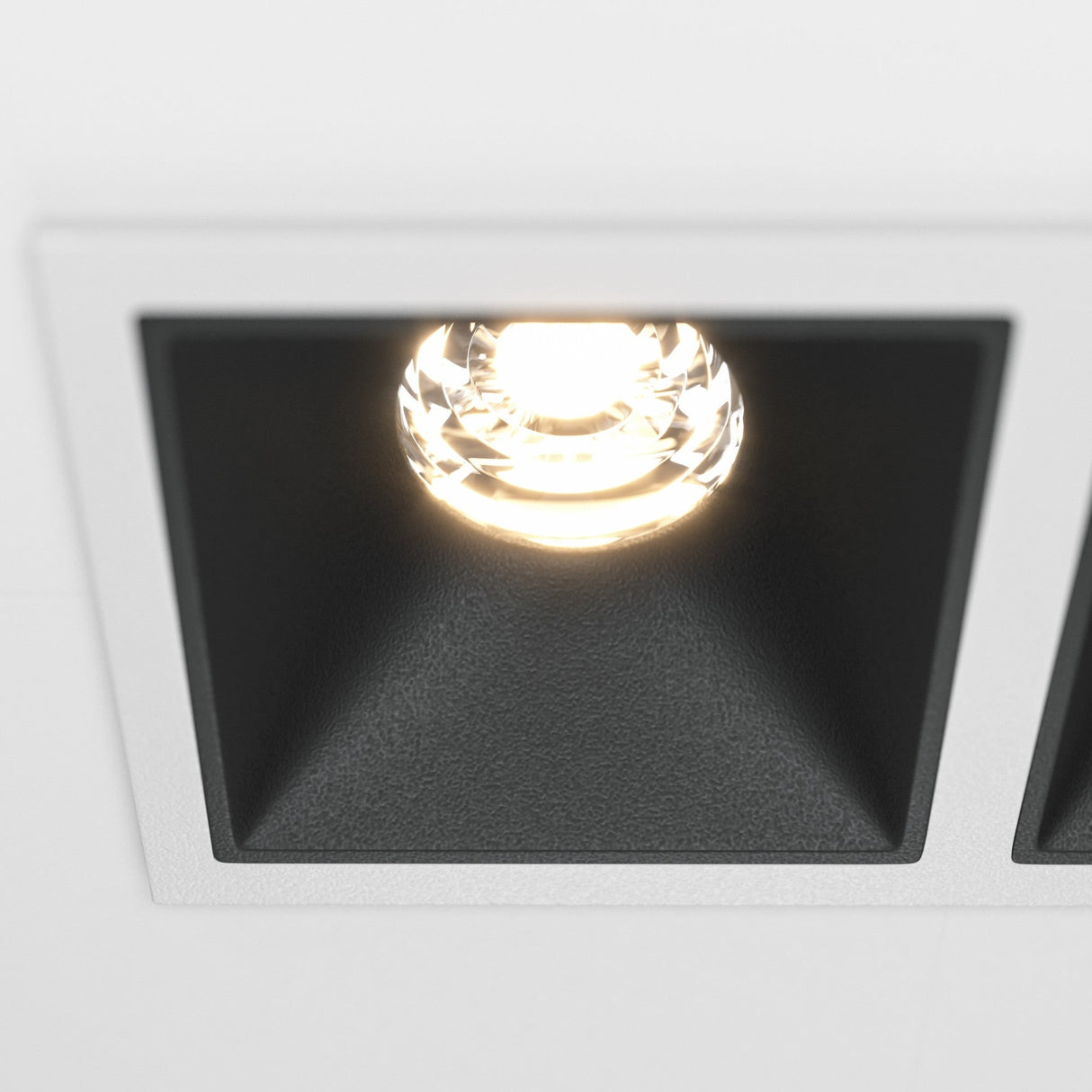 Detailed view of the Alfa LED Twin Fixed Square Recessed Downlight in white and black, showcasing its bold appearance.