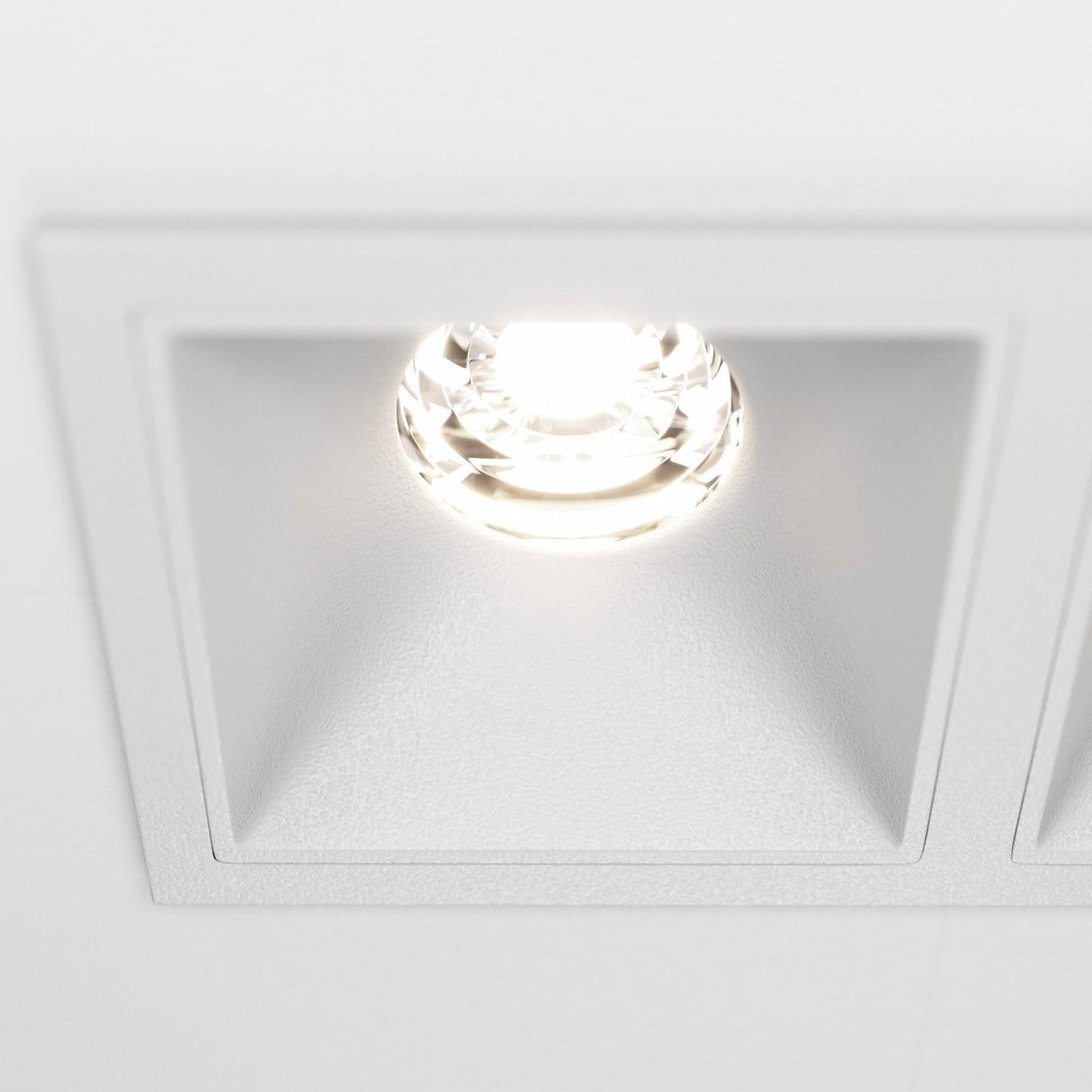 Close-up of the Alfa LED Twin Fixed Square Recessed Downlight in white, highlighting its refined design.