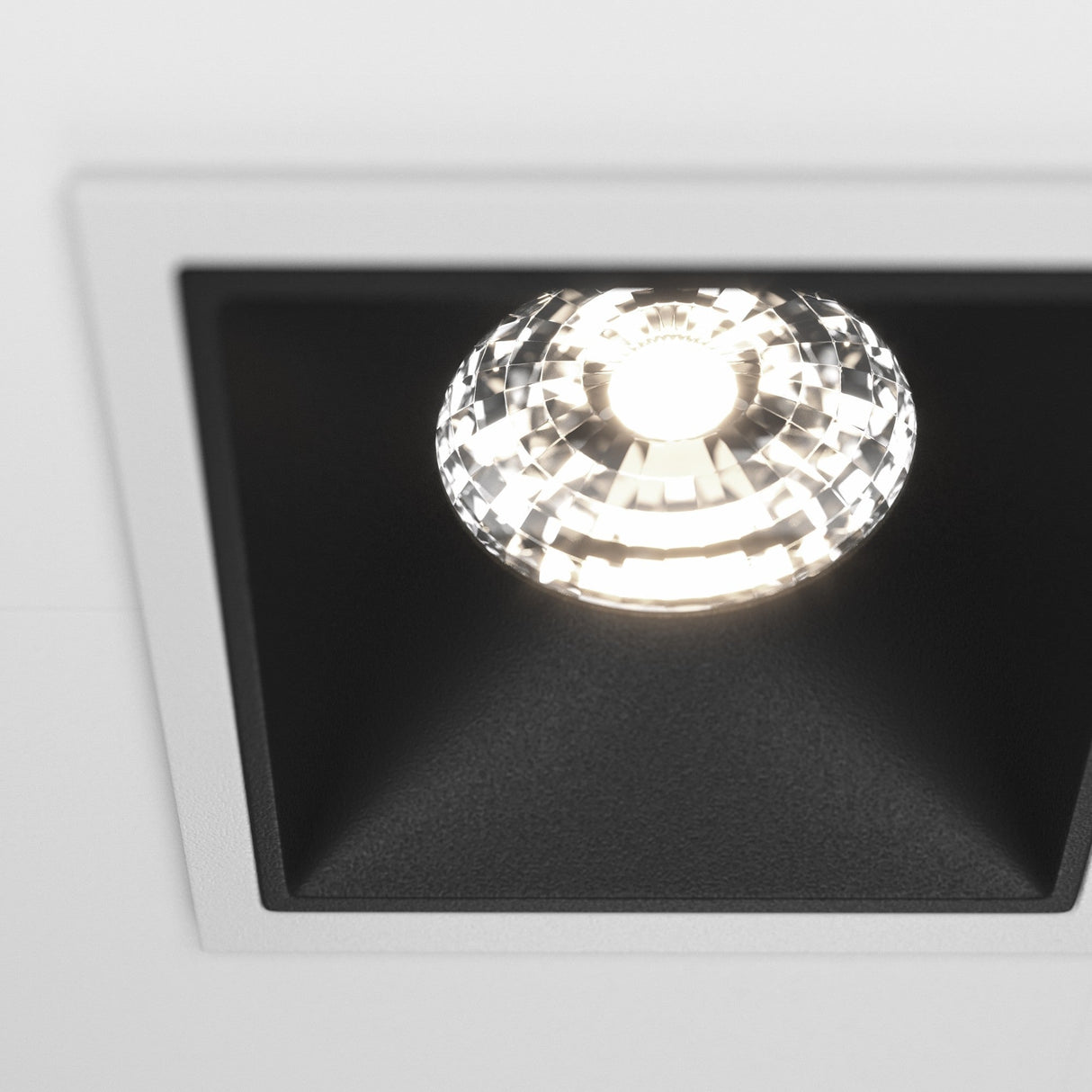 Close-up view of the Alfa LED Dimmable Fixed Square Recessed Twin Downlight in white and black, showcasing its sleek design.