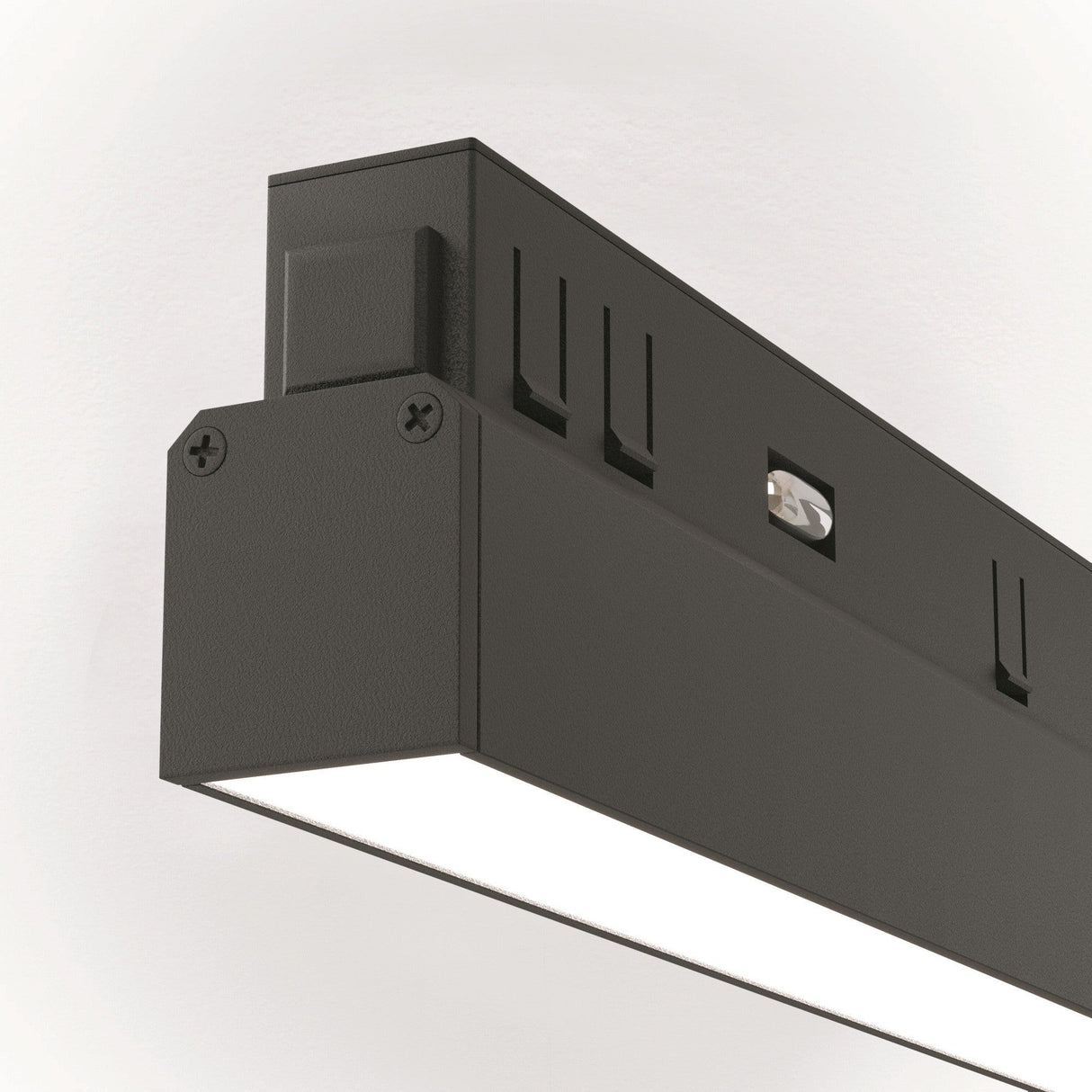 Close-up of the Basis CCT LED Track Light mounted on a wall. This dimmable, matte black light emits a bright, even glow from the bottom panel and integrates seamlessly into any Bluetooth Mesh system.