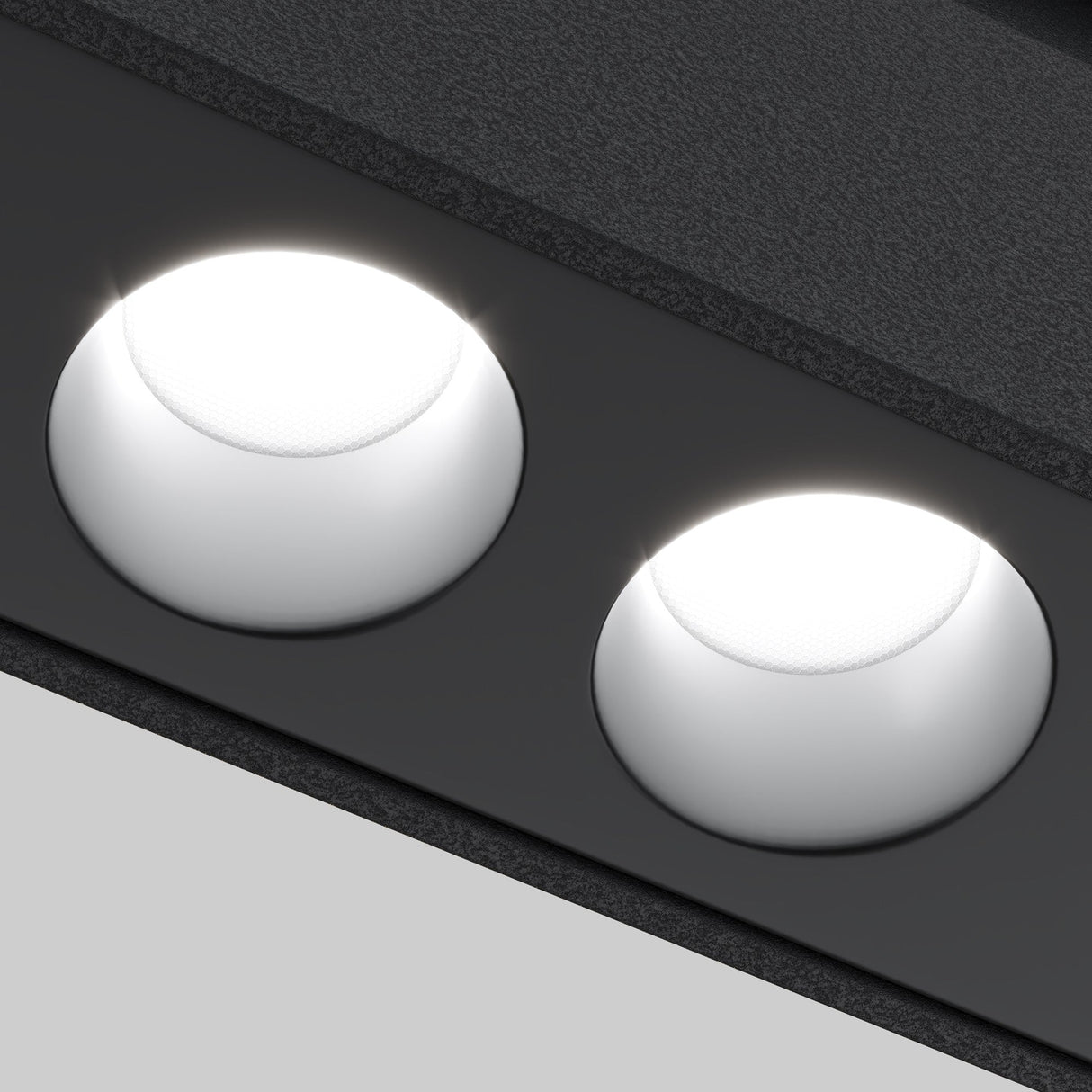 Close-up of two Points DALI CCT LED dimmable track lights with a black frame, emitting bright white light against a grey background. Featuring DALI technology, they offer adjustable color temperature from 2700-6000K for the perfect ambiance.