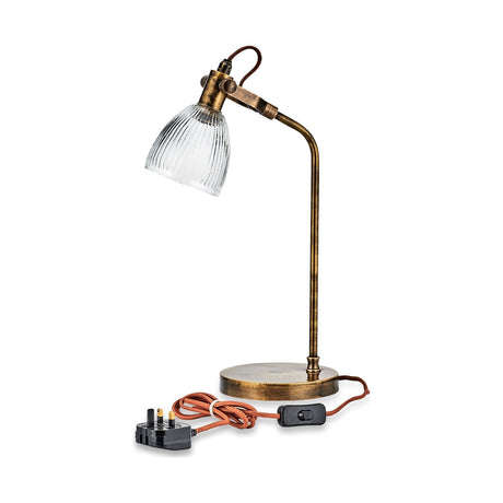 Rarni Recycled Glass Table Lamp in antique brass with a curved stem, round base, knuckle joint, and ribbed clear glass dome shade, shown with plug on a white background.