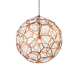 The Rango Acid Small Pendant Light in copper features an intricate spherical metal frame with an open lattice design, casting a warm glow from the bulb inside. It hangs elegantly from a single black cord against a white background.