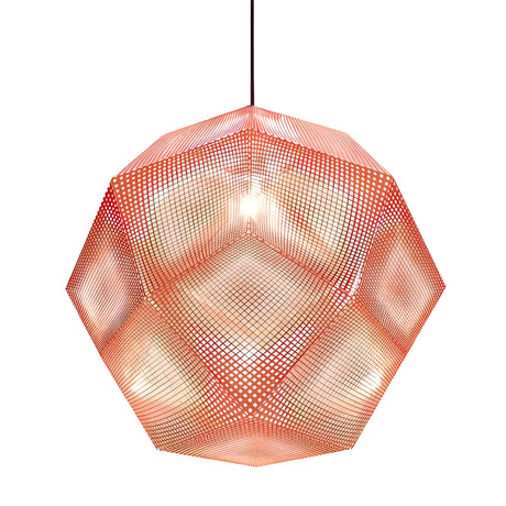The Rango Large Pendant Light - Copper is a dodecahedron-shaped copper pendant with red acid-etched perforated panels, a glowing bulb inside, and hangs from a black cord against a white background.