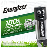 The Energizer battery mascot beams while holding a pack of C Energizer Power Plus rechargeable batteries in eco-friendly packaging. Text highlights 100% recyclable, plastic-free packaging against a lush grass backdrop and the iconic Energizer logo, boasting 2500mAh power.