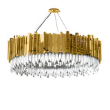The Royal 6-12 Crystal Light Chandelier - Gold features a modern yet timeless design with a luxurious gold finish, sparkling silver crystal-like prisms, and is elegantly suspended by three thin cables from a round ceiling mount.