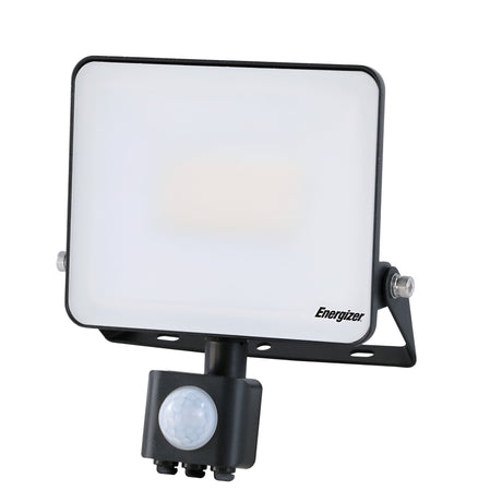 The Energizer 30W LED PIR Floodlight - 6,000K (Daylight) is a rectangular outdoor unit in white, accented by a sleek black frame and mounting bracket. It includes a 30W floodlight and features a small, round PIR motion sensor placed at the bottom center. The Energizer brand is clearly displayed on the front for easy recognition.