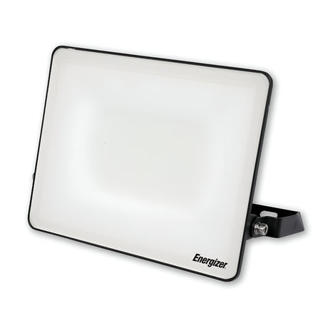 The Energizer 50W LED Floodlight - 6,500K (Daylight) is a rectangular, flat-panel work light with a white front and black trim, mounted on a black adjustable stand. This energy-efficient floodlight features the word Energizer printed in black on the bottom right corner, making it ideal for outdoor lighting needs.