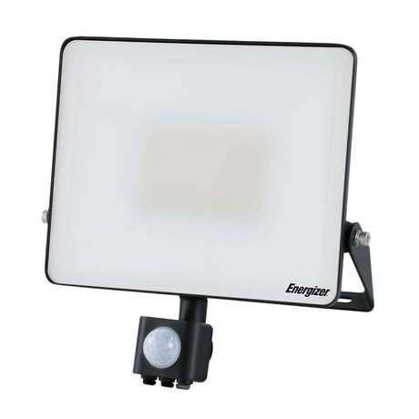 The Energizer 50W LED PIR Floodlight - 6,500K (Daylight) boasts an IP44 rating and a sleek black stand supporting its rectangular, flat panel design. Featuring a PIR motion sensor, the Energizer brand name is elegantly displayed in the bottom right corner of the front panel.