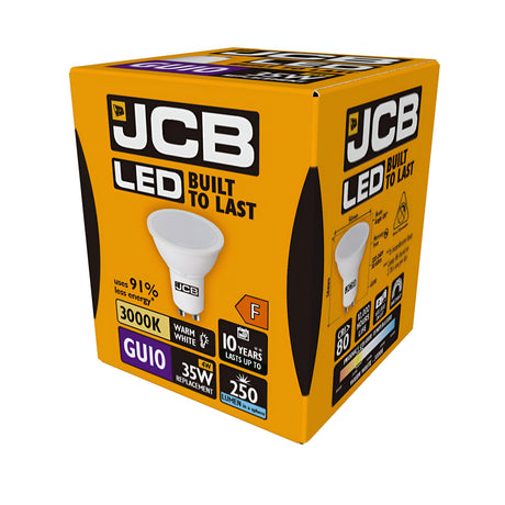 A box of JCB 4W GU10 Non-Dimmable LED bulbs in warm white at 3000K offers an energy-efficient lighting solution, serving as a perfect replacement for traditional 35W bulbs. These bulbs have an F energy rating, emit a brightness of 250 lumens, and boast a lifespan of up to 10 years. The packaging features predominantly orange color with black and white text.