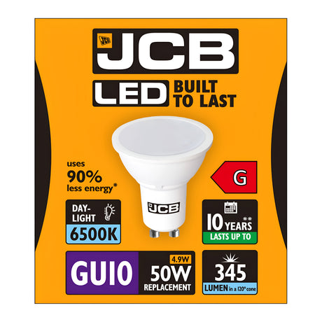 The packaging for the JCB 4.9W GU10 Non-Dimmable LED Bulb - Daylight, 6500K features an orange box with a black and white logo. It highlights the bulb's 90% energy savings, daylight color temperature of 6500K, a lifespan of up to 10 years, and luminous output of 345 lumens. This energy-efficient bulb in class G replaces a traditional 50W bulb using only 4.9W.
