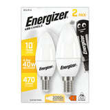 The packaging for the Energizer 4.9W Non-Dimmable LED Candle Bulb - Warm White, E14, 3000K (2 Pack) highlights its energy efficiency by providing the same brightness as a traditional 40W bulb while delivering a cozy warm white glow of 3000K and emitting 470 lumens. It features two durable bulbs and is adorned with a playful cartoon battery character in the top right corner.