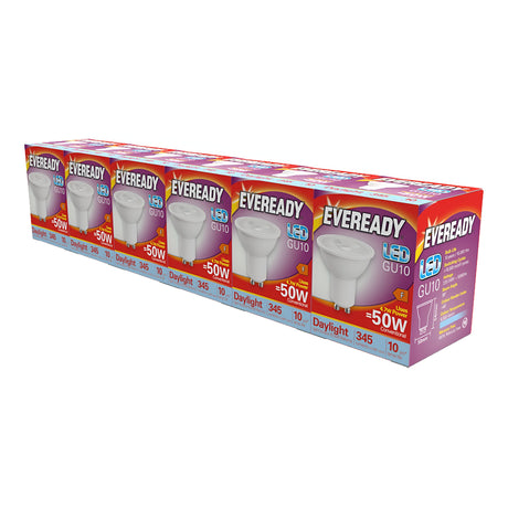 A 5+1 pack of Eveready 4.7W GU10 non-dimmable LED bulbs in daylight, 6500K, offers energy efficiency with a consumption of just 4.7W while being equivalent to traditional 50W bulbs. The packaging is designed with product information displayed in red, yellow, and purple colors, and the bulbs are arranged in a straight line.