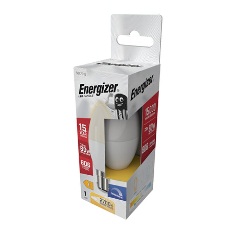 The packaging of the Energizer 7.3W Dimmable LED Candle Bulb, equipped with a B15 bayonet cap, highlights its extended 15-year lifespan and brightness of 806 lumens, matching that of a traditional 60W bulb. The box features the beloved Energizer mascot and emphasizes the bulb's warm white light at 2700K.