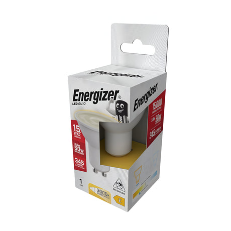 The Energizer-1 3.6W GU10 Non-Dimmable LED Bulb in warm white at 3000K is packaged with a promise of a 15,000-hour lifespan and an output of 345 lumens. Its packaging features a white box adorned with black and red text alongside a cartoon light bulb character.