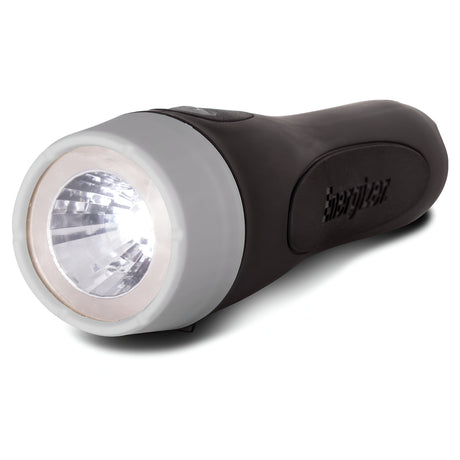 A black Energizer LED Torch 25 Lumen with a gray front, resting on its side. The flashlight is turned on and casting powerful brightness from its lens. The design is sleek and ergonomic.