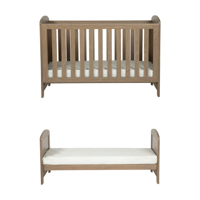 Seeker Convertible Cot Bed & 3 Position Base in Drift, shown as a slatted cot with mattress and as a converted toddler bed, oak-effect wood finish, on a plain white background.