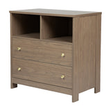 Seeker Changing Table with Drawers in Drift, MDF wood-finish unit with two open compartments and two drawers with brushed metal knobs, on a plain white background.