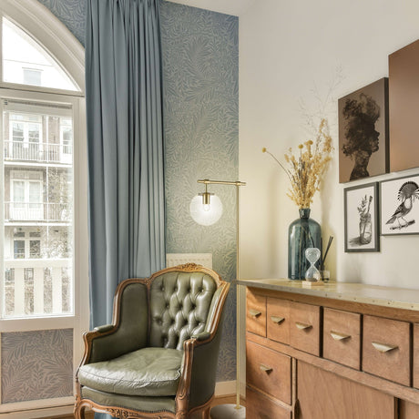 Avenue floor lamp in brass finish, shown in a room setting