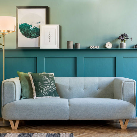Clifton 3 light floor lamp in brass finish, shown in a room setting