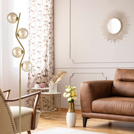 Cosmic 4 light floor lamp in black and brass finish, shown in a room setting