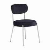 Smith Dining Chair in black velvet with a rounded upholstered backrest and seat, set on slim silver metal legs, shown on a plain white background.