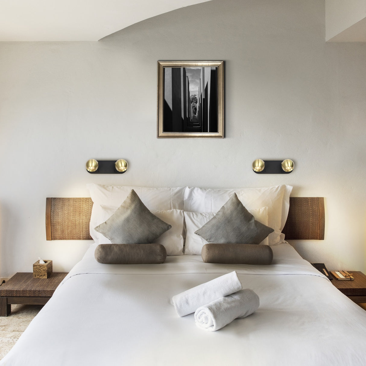 Lens 2 light wall light in black and brass finish, shown in a room setting