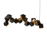 The Spar Linear Suspension Light - Black & Gold features interconnected black geometric forms with illuminated interiors, suspended by a thin cord, creating striking symmetry against a white background.