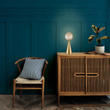 Quasar table lamp in brass finish, shown in a room setting