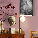 Axle table lamp in black and brass finish, shown in a room setting