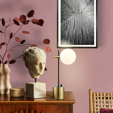 Axle table lamp in black and brass finish, shown in a room setting