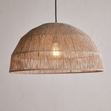 Tivi Natural Jute Lampshade, a wide dome pendant shade with vertical jute cord bound by horizontal bands, hung from a black cord against a plain light grey background, light bulb glowing inside.