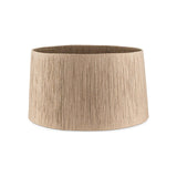 Tiwa Small Woven Jute Lampshade in natural straw-toned jute cord with a tapered drum shape, fine vertical ribbed texture, and visible brass fitting ring, on a plain white background.