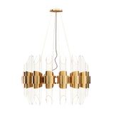The Tycho 6 Light Crystal Chandelier in Gold & White features a modern circular design with ribbed glass panels and gold metal bands, suspended by thin wires from a round ceiling mount.