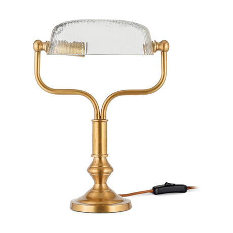 Ulani Vintage Desk Lamp in antique brass, banker-style with ribbed clear glass dome shade on a twin-stem yoke and turned column base, shown on a plain white background.