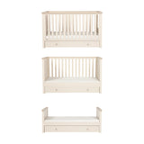 Wanderer Convertible Cot Bed with Drawer in Cashmere, shown in three configurations—cot, toddler bed, and daybed—with slatted sides, oak-effect trim, and under-bed drawer on a white background.