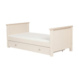 Wanderer Convertible Cot Bed with Drawer in Cashmere, cream finish with oak-effect trim, low panel ends, mattress included, and under-bed storage drawer with knob handles.