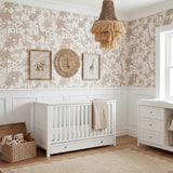 White Wanderer Convertible Cot Bed with slatted sides and under-bed drawer, shown in a safari-themed nursery with wallpaper and framed animal prints.