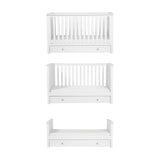 Wanderer Convertible Cot Bed with Drawer in white, shown in three stages from full cot to toddler bed with under-bed drawer, on a plain white background.