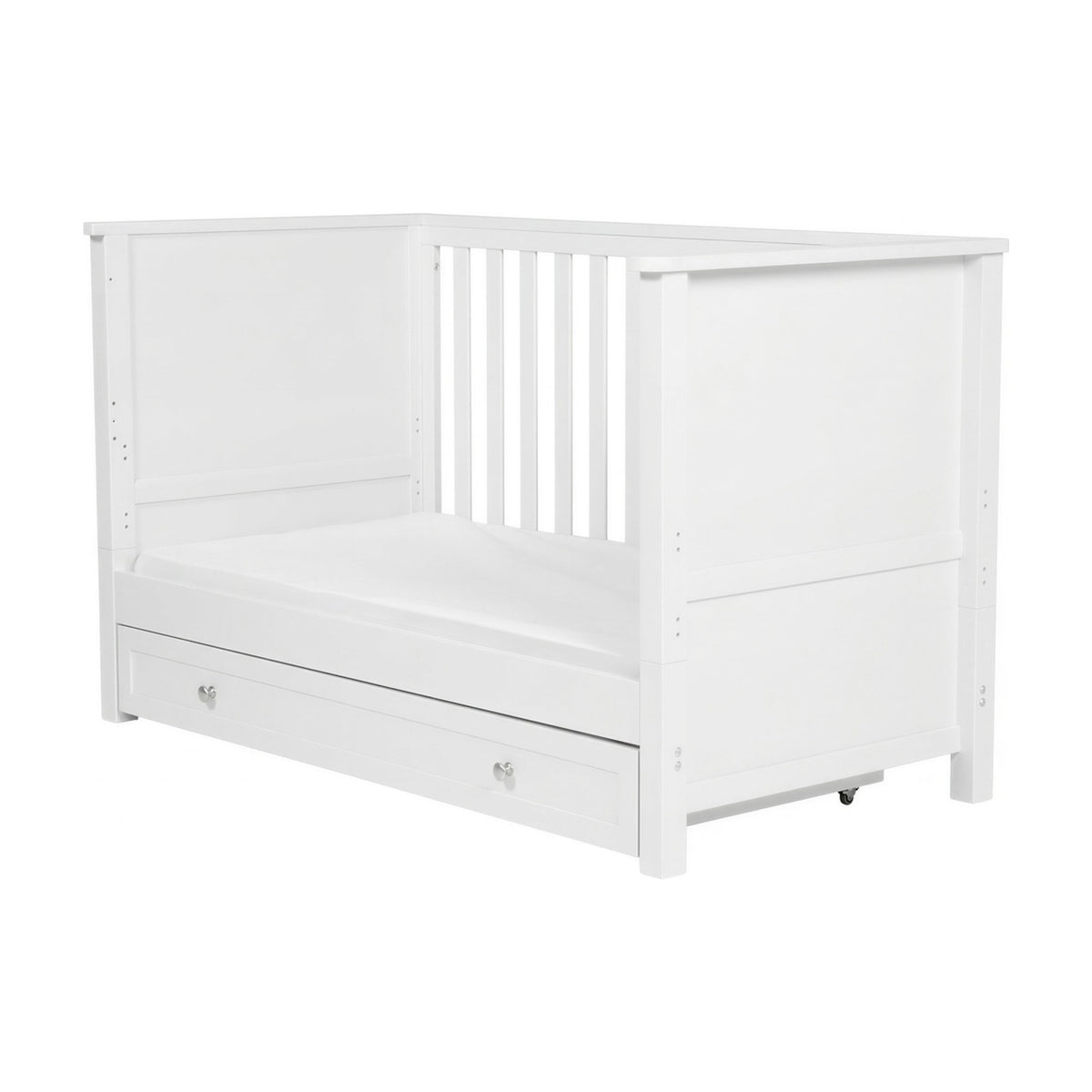 Wanderer Convertible Cot Bed with Drawer in white MDF, shown as a day bed with slatted end panel, mattress base, and a castor-mounted under-bed drawer, on a plain background.